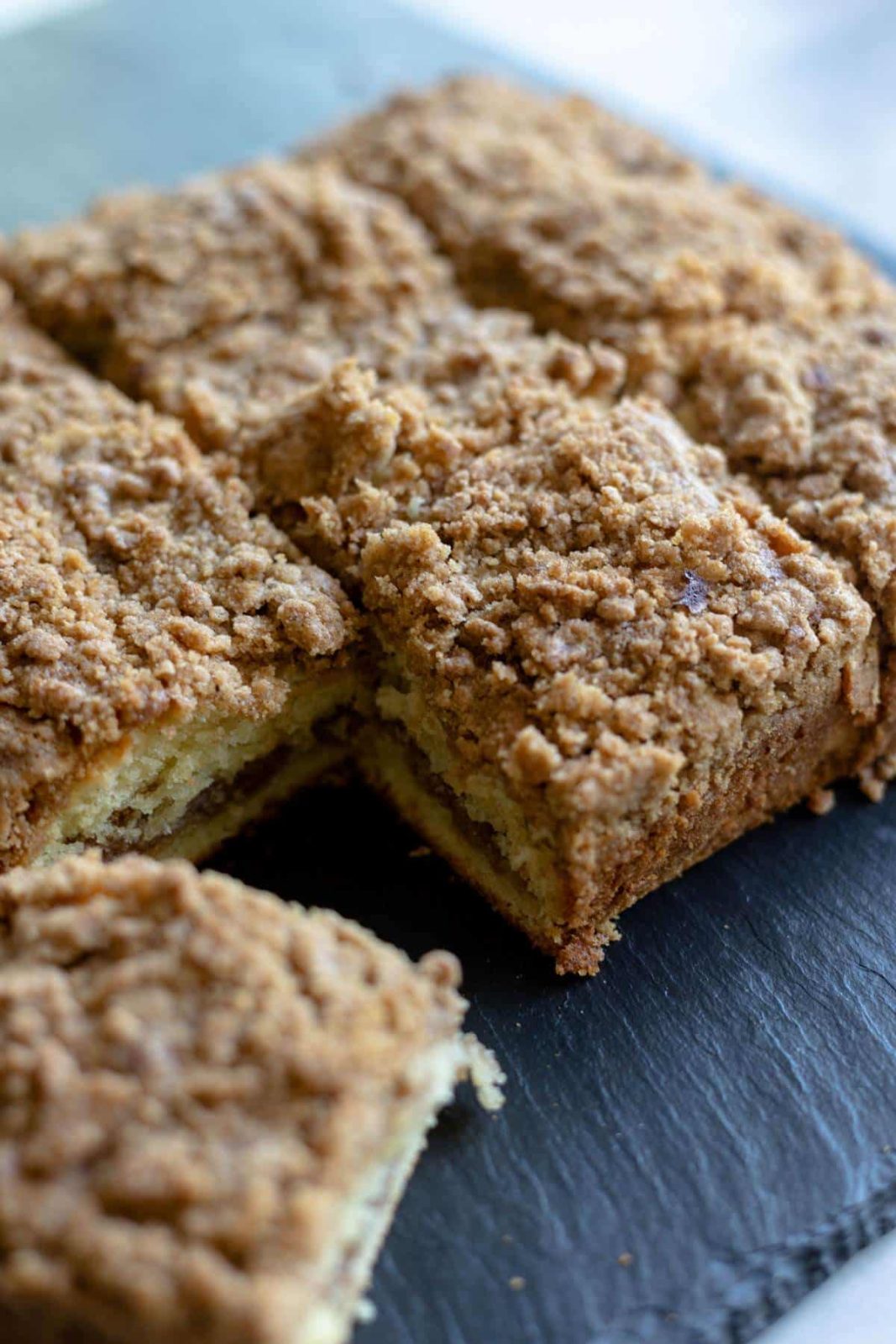 sliced coffee cake cut into squares with the corner square sticking out